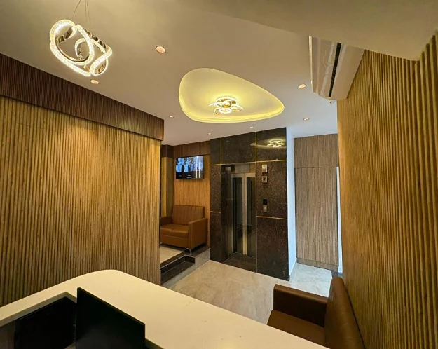 Hotel Royal Inn lobby with a lit ceiling and lift